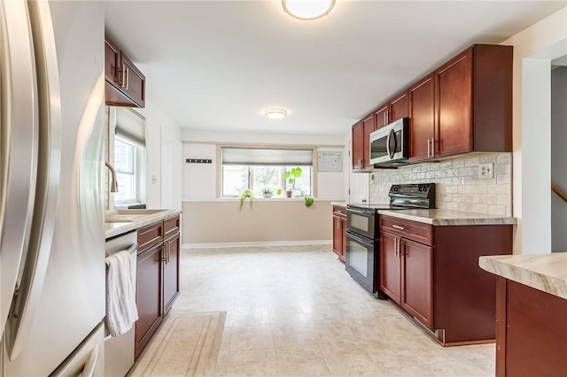 1948 Five Mile Line Rd, Penfield, NY 14526 - kitchen featuring appliances with stainless steel finishes, tasteful backsplash, light countertops, and dark brown cabinets