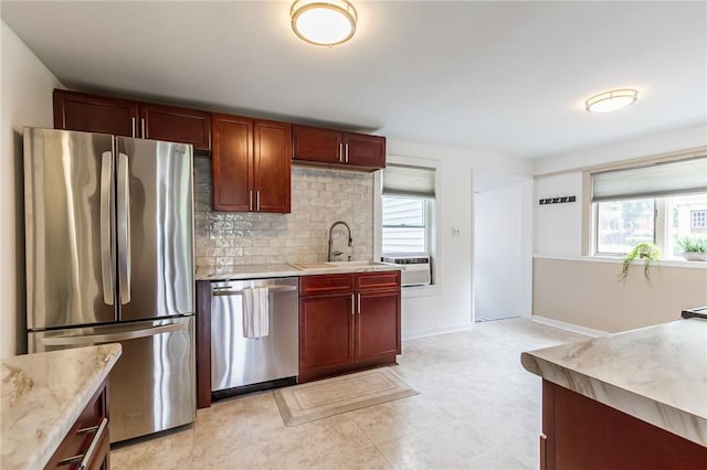 1948 Five Mile Line Rd, Penfield, NY 14526 - kitchen featuring appliances with stainless steel finishes, reddish brown cabinets, backsplash, and light stone counters