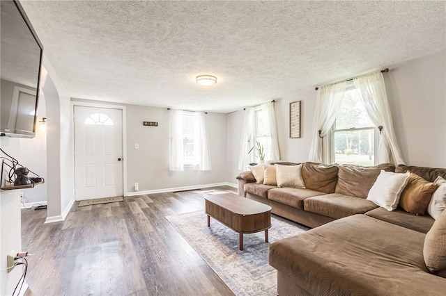 1948 Five Mile Line Rd, Penfield, NY 14526 - living room with wood finished floors, a textured ceiling, and arched walkways