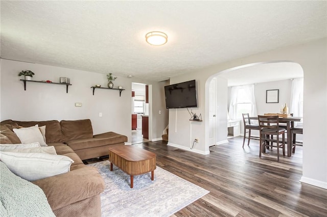 1948 Five Mile Line Rd, Penfield, NY 14526 - living room featuring arched walkways, dark wood finished floors, and stairs