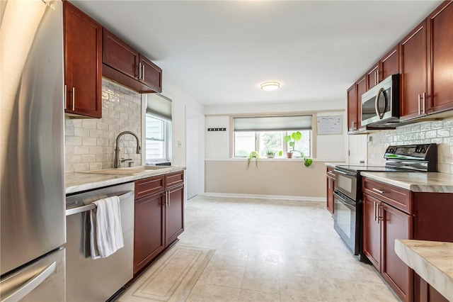 1948 Five Mile Line Rd, Penfield, NY 14526 - kitchen with appliances with stainless steel finishes, reddish brown cabinets, and light countertops