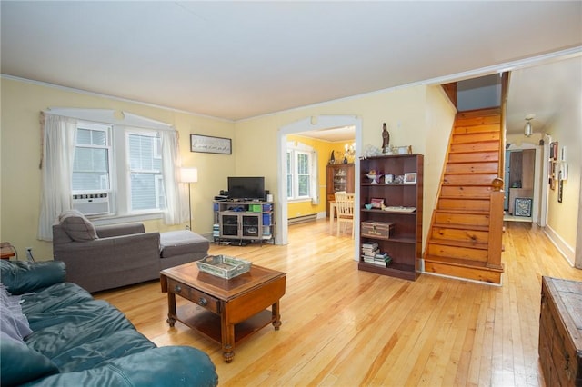 130 Stark Ave, Milo, NY 14527 - living room featuring light wood-type flooring, stairway, crown molding, a baseboard radiator, and arched walkways