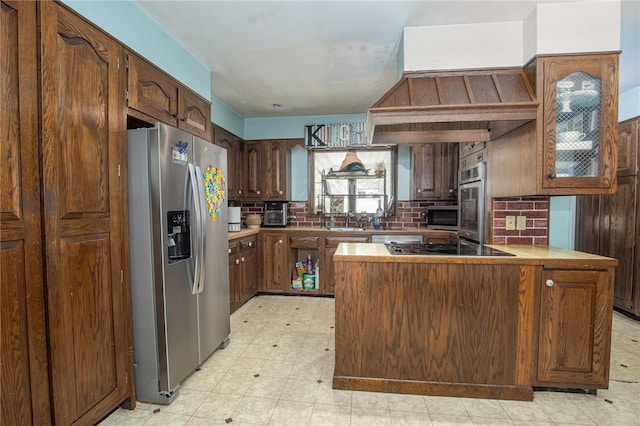130 Stark Ave, Milo, NY 14527 - kitchen with stainless steel appliances, a peninsula, custom exhaust hood, backsplash, and light flooring
