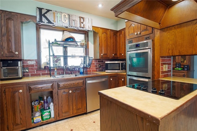 130 Stark Ave, Milo, NY 14527 - kitchen featuring appliances with stainless steel finishes, tasteful backsplash, brown cabinetry, and light tile patterned floors