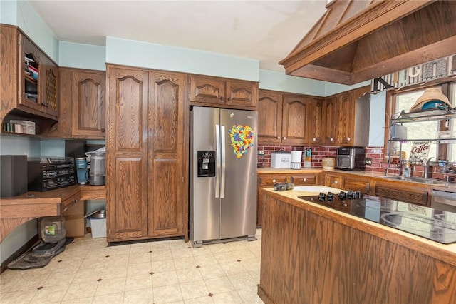 130 Stark Ave, Milo, NY 14527 - kitchen featuring stainless steel appliances, decorative backsplash, brown cabinets, and light floors