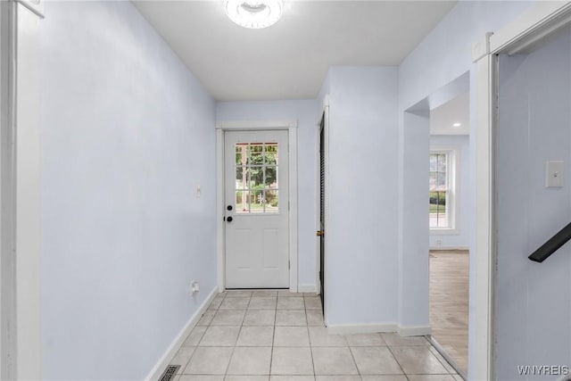 23 Lombardy St, Lancaster, NY 14086 - doorway to outside featuring light tile patterned floors and baseboards
