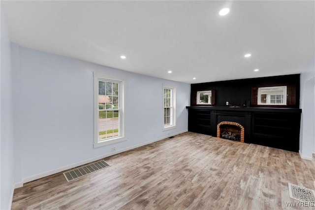 23 Lombardy St, Lancaster, NY 14086 - unfurnished living room with wood finished floors, recessed lighting, and a brick fireplace