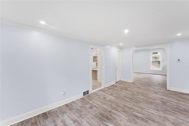 23 Lombardy St, Lancaster, NY 14086 - spare room featuring wood finished floors, arched walkways, and recessed lighting