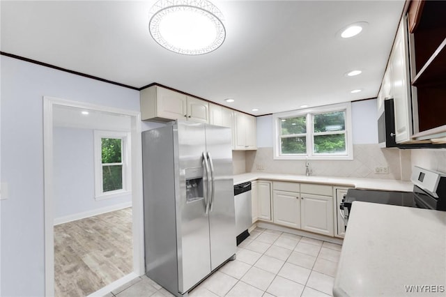 23 Lombardy St, Lancaster, NY 14086 - kitchen featuring appliances with stainless steel finishes, light countertops, white cabinetry, tasteful backsplash, and recessed lighting