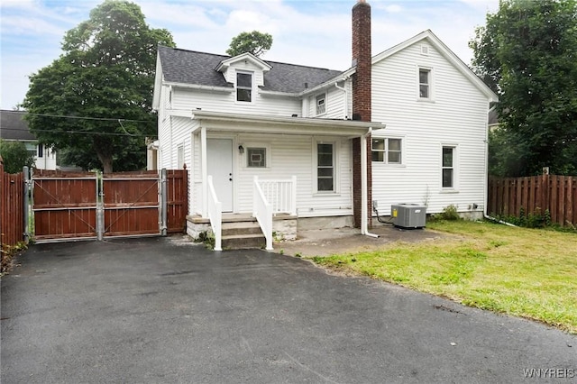 23 Lombardy St, Lancaster, NY 14086 - back of house with a chimney, a gate, and a shingled roof
