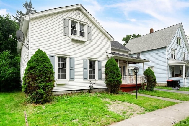 23 Lombardy St, Lancaster, NY 14086 - view of front of house featuring a front yard, covered porch, and roof with shingles