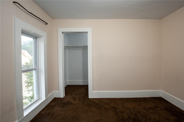 17 Orchard St, Canisteo, NY 14823 - unfurnished bedroom with dark carpet, multiple windows, and a closet