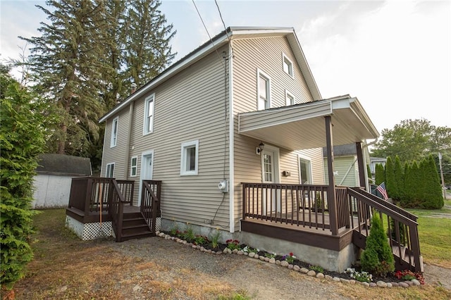 17 Orchard St, Canisteo, NY 14823 - view of side of home with covered porch and a wooden deck
