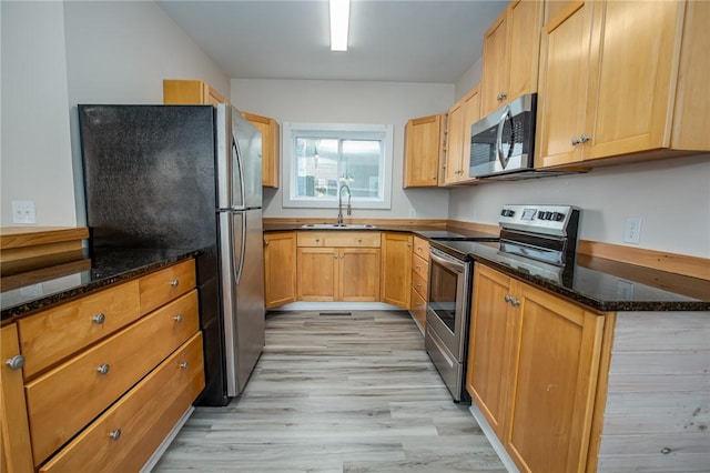 17 Orchard St, Canisteo, NY 14823 - kitchen with stainless steel appliances, light wood-style floors, and dark stone counters