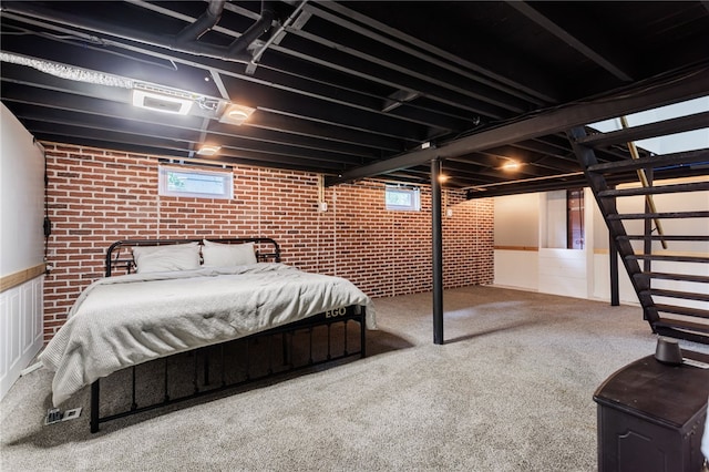773 Marshall Rd, Chili, NY 14624 - carpeted bedroom with brick wall, multiple windows, and a wainscoted wall