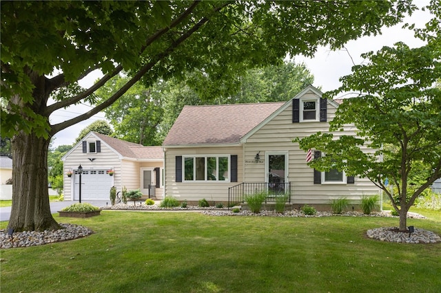 773 Marshall Rd, Chili, NY 14624 - cape cod home featuring a front lawn, an attached garage, roof with shingles, and driveway