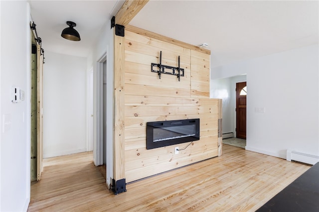 773 Marshall Rd, Chili, NY 14624 - unfurnished living room featuring light wood-type flooring, baseboard heating, and a glass covered fireplace