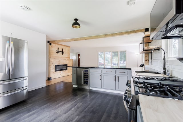 773 Marshall Rd, Chili, NY 14624 - kitchen featuring stainless steel refrigerator with ice dispenser, gas range oven, a peninsula, wine cooler, and dark wood finished floors