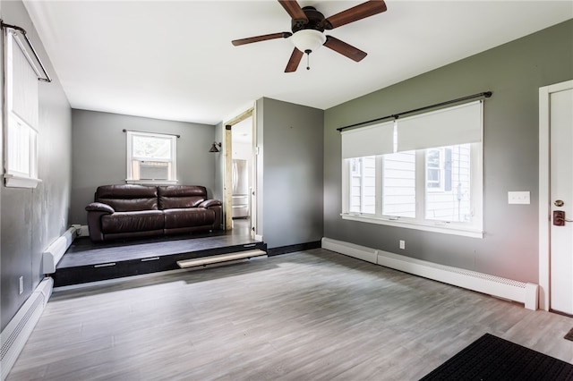 773 Marshall Rd, Chili, NY 14624 - living area with a baseboard heating unit, ceiling fan, wood finished floors, and baseboard heating