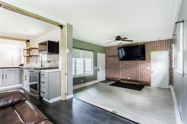 773 Marshall Rd, Chili, NY 14624 - living area with brick wall, a ceiling fan, and dark wood finished floors