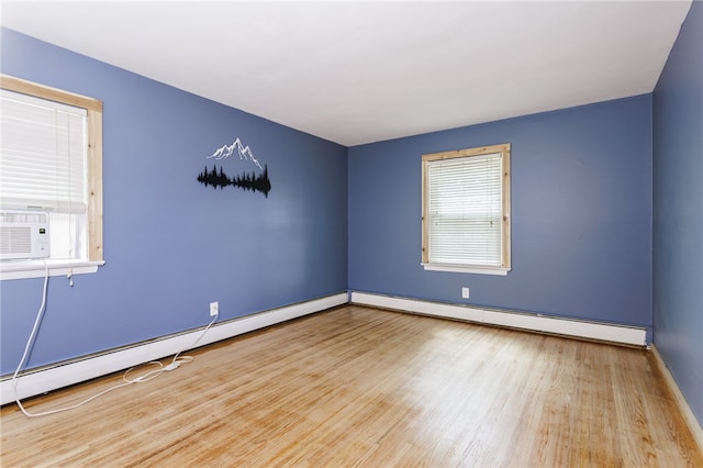 773 Marshall Rd, Chili, NY 14624 - unfurnished room featuring wood finished floors, plenty of natural light, and a baseboard heating unit