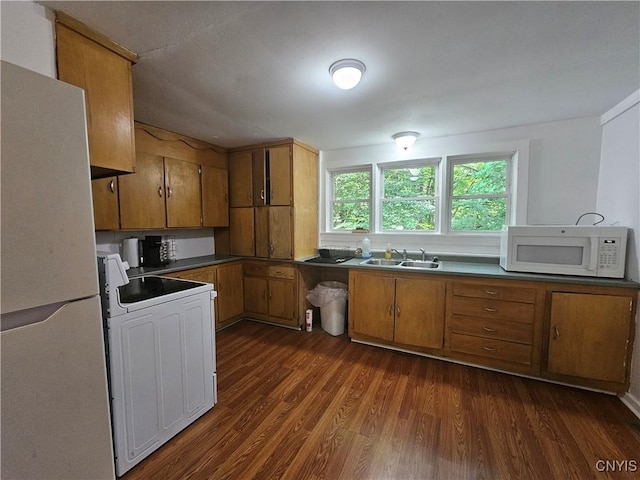 147 N St, Constantia, NY 13042 - kitchen featuring white appliances, brown cabinetry, dark wood-style floors, and dark countertops