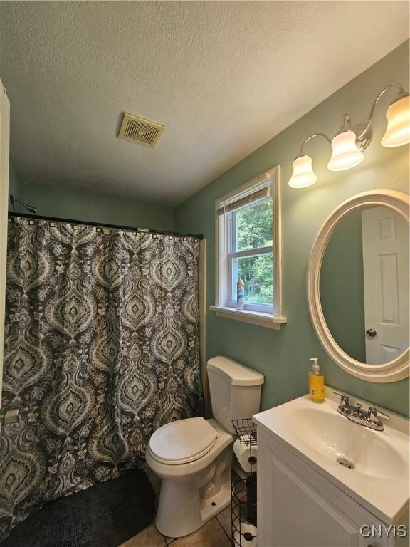 147 N St, Constantia, NY 13042 - bathroom with vanity, tile patterned floors, and a textured ceiling