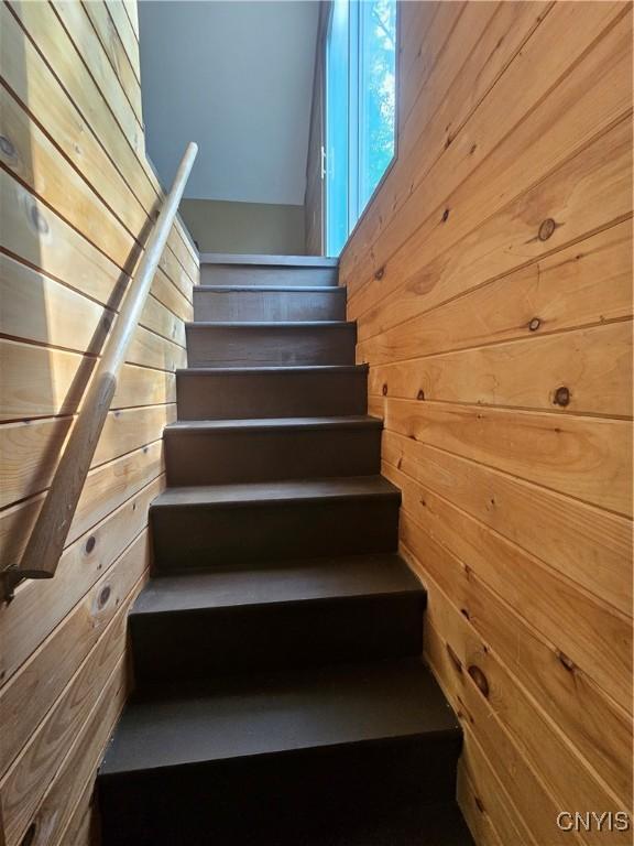 147 N St, Constantia, NY 13042 - staircase featuring wood walls