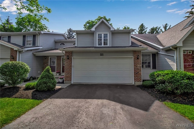21 Towne Square Dr, Lancaster, NY 14086 - view of front of house featuring driveway, brick siding, a garage, and a shingled roof