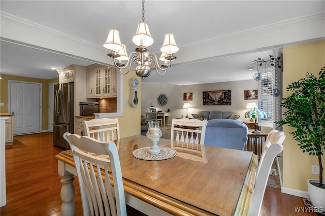 21 Towne Square Dr, Lancaster, NY 14086 - dining area featuring wood finished floors, a chandelier, and ornamental molding