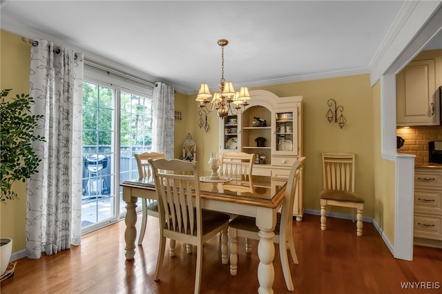 21 Towne Square Dr, Lancaster, NY 14086 - dining area with a chandelier, wood finished floors, and crown molding