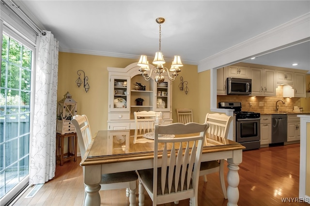 21 Towne Square Dr, Lancaster, NY 14086 - dining room with a chandelier, light wood finished floors, and crown molding