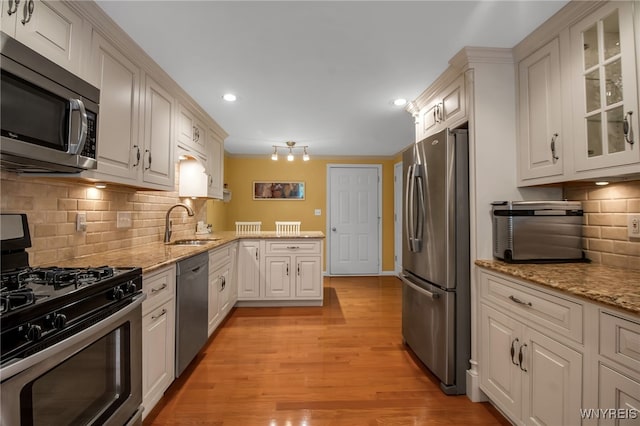 21 Towne Square Dr, Lancaster, NY 14086 - kitchen with appliances with stainless steel finishes, glass insert cabinets, recessed lighting, white cabinetry, and light wood-type flooring