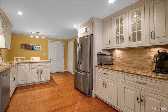 21 Towne Square Dr, Lancaster, NY 14086 - kitchen with appliances with stainless steel finishes, tasteful backsplash, glass insert cabinets, light wood-type flooring, and recessed lighting