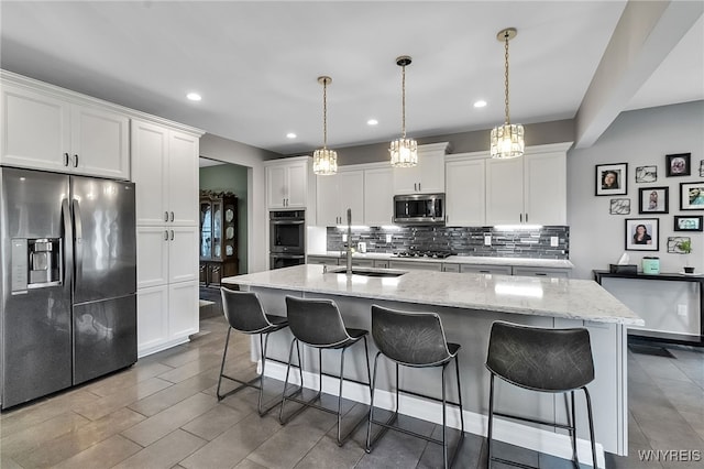 6132 Railroad St, Clarence, NY 14032 - kitchen featuring appliances with stainless steel finishes, recessed lighting, tasteful backsplash, a breakfast bar area, and white cabinetry