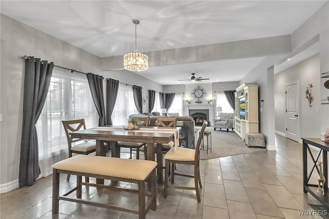 6132 Railroad St, Clarence, NY 14032 - dining area with plenty of natural light, ceiling fan, a fireplace, and a chandelier