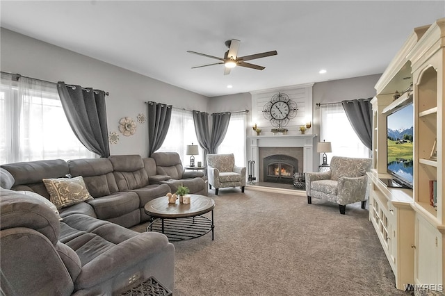 6132 Railroad St, Clarence, NY 14032 - carpeted living area featuring a ceiling fan, a lit fireplace, and recessed lighting