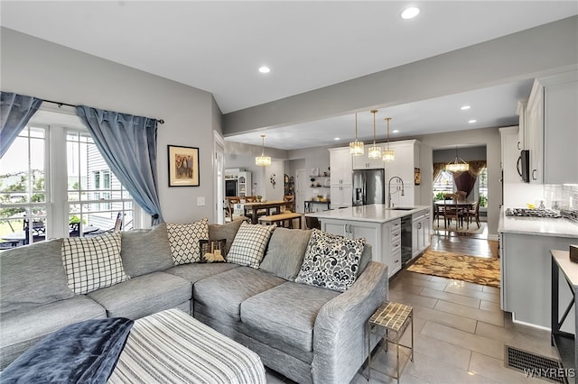 6132 Railroad St, Clarence, NY 14032 - living area with recessed lighting, dark tile patterned flooring, and a chandelier