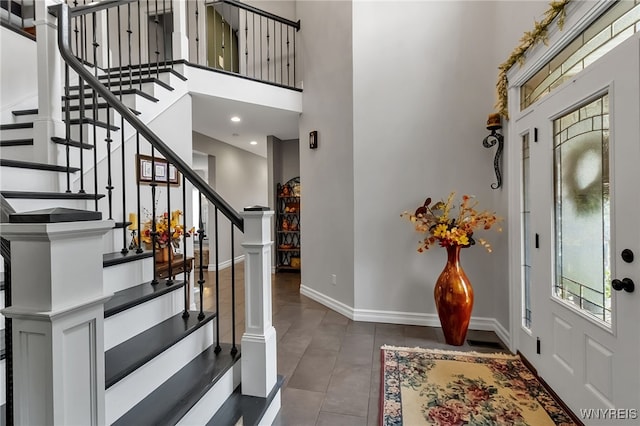 6132 Railroad St, Clarence, NY 14032 - foyer with a high ceiling, stairway, and tile patterned flooring