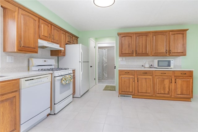 15 Kearney Dr, Irondequoit, NY 14617 - kitchen featuring white appliances, under cabinet range hood, decorative backsplash, and light countertops