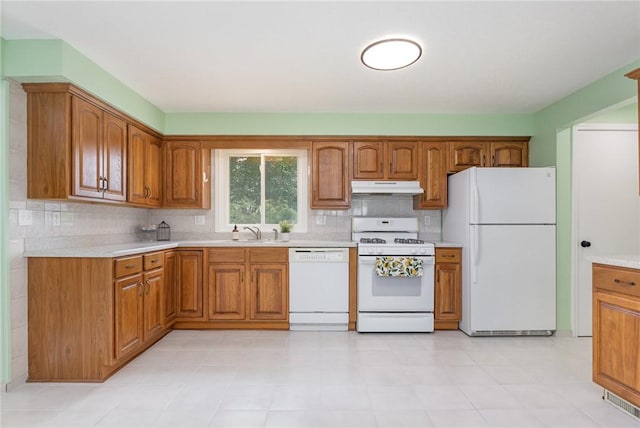 15 Kearney Dr, Irondequoit, NY 14617 - kitchen with white appliances, under cabinet range hood, brown cabinets, and light countertops