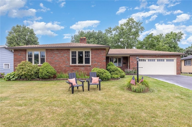15 Kearney Dr, Irondequoit, NY 14617 - view of front of property with a garage, brick siding, a chimney, driveway, and a front lawn