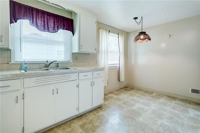 3201 Elmwood Ave, Brighton, NY 14618 - kitchen with light countertops, white cabinets, and hanging light fixtures