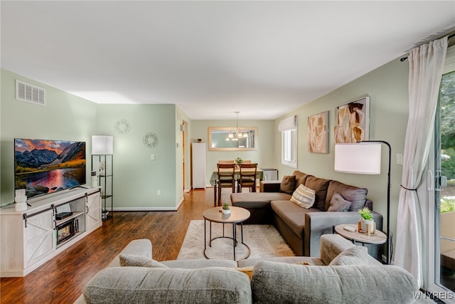135 Charter Oaks Dr Unit 1, Amherst, NY 14228 - living room featuring a chandelier and dark wood-type flooring