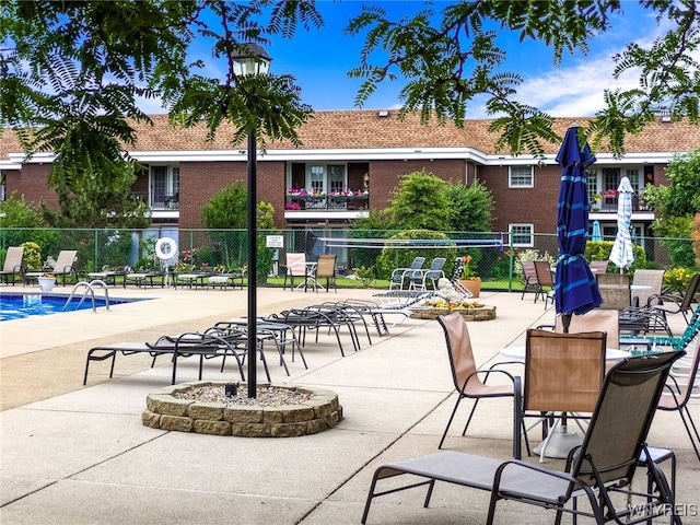 135 Charter Oaks Dr Unit 1, Amherst, NY 14228 - view of patio / terrace with a community pool and an outdoor fire pit
