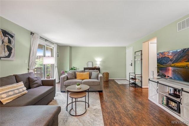 135 Charter Oaks Dr Unit 1, Amherst, NY 14228 - living room with dark wood-type flooring and baseboards