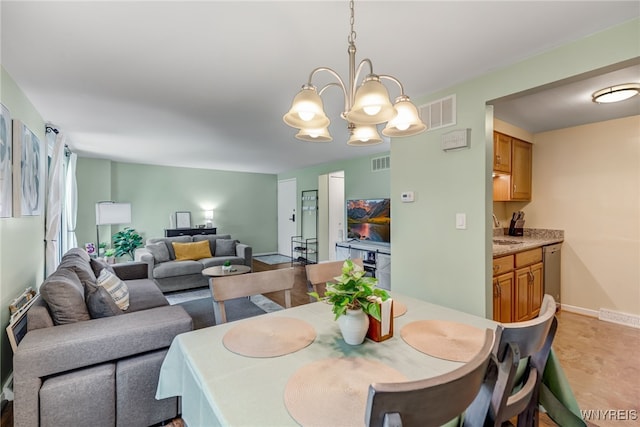 135 Charter Oaks Dr Unit 1, Amherst, NY 14228 - dining space with a chandelier and baseboards