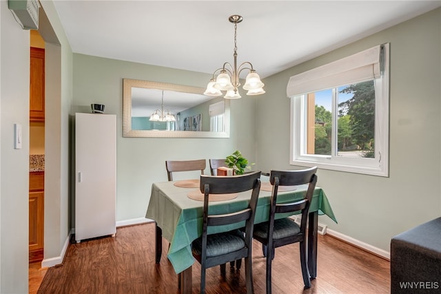 135 Charter Oaks Dr Unit 1, Amherst, NY 14228 - dining area featuring a chandelier and wood finished floors