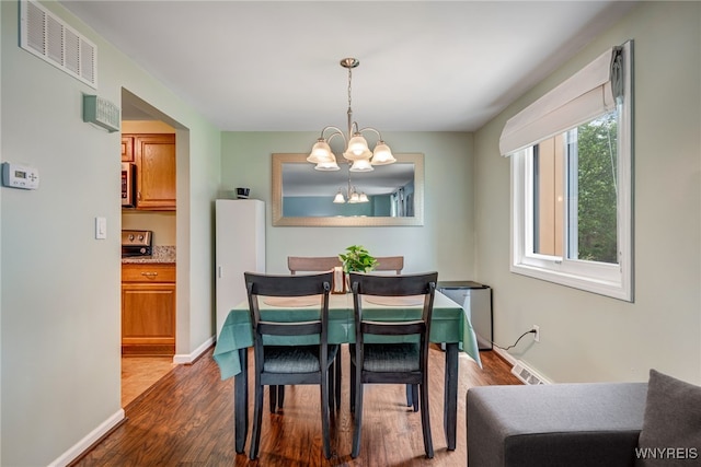 135 Charter Oaks Dr Unit 1, Amherst, NY 14228 - dining area with a chandelier and dark wood-style floors