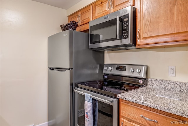 135 Charter Oaks Dr Unit 1, Amherst, NY 14228 - kitchen featuring stainless steel appliances and light stone countertops